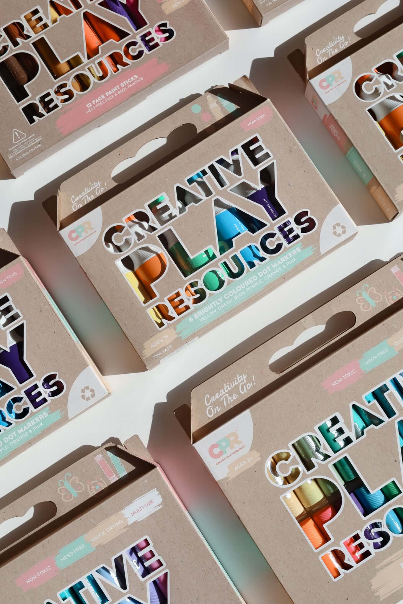 Multiple boxes of 'Creative Play Resources' with colorful text on a white background