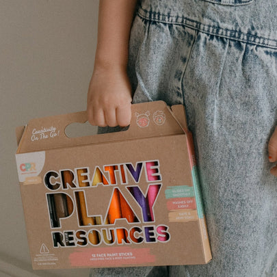 child holding face paint sticks