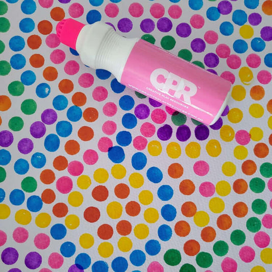 Dot painting techniques with vibrant colors created by a pink dot paint marker on a colorful dot-patterned background.