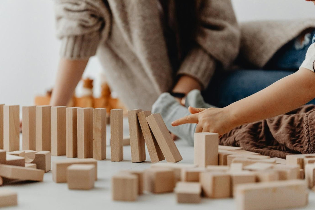 A child playing with small blocks helps develop spatial awareness, problem-solving skills, and fine motor control