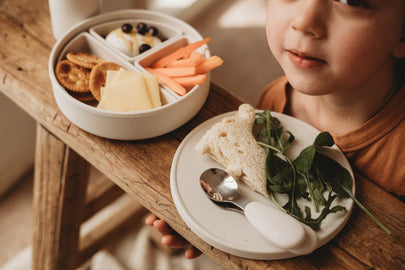 Child enjoying a meal with a 5 Piece Silicone Multifunctional Plate with Dividers & Lid.