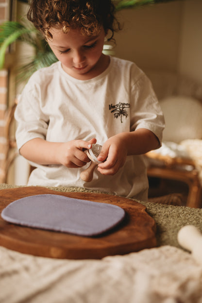 child using silicone sea creature stamps for sensory play