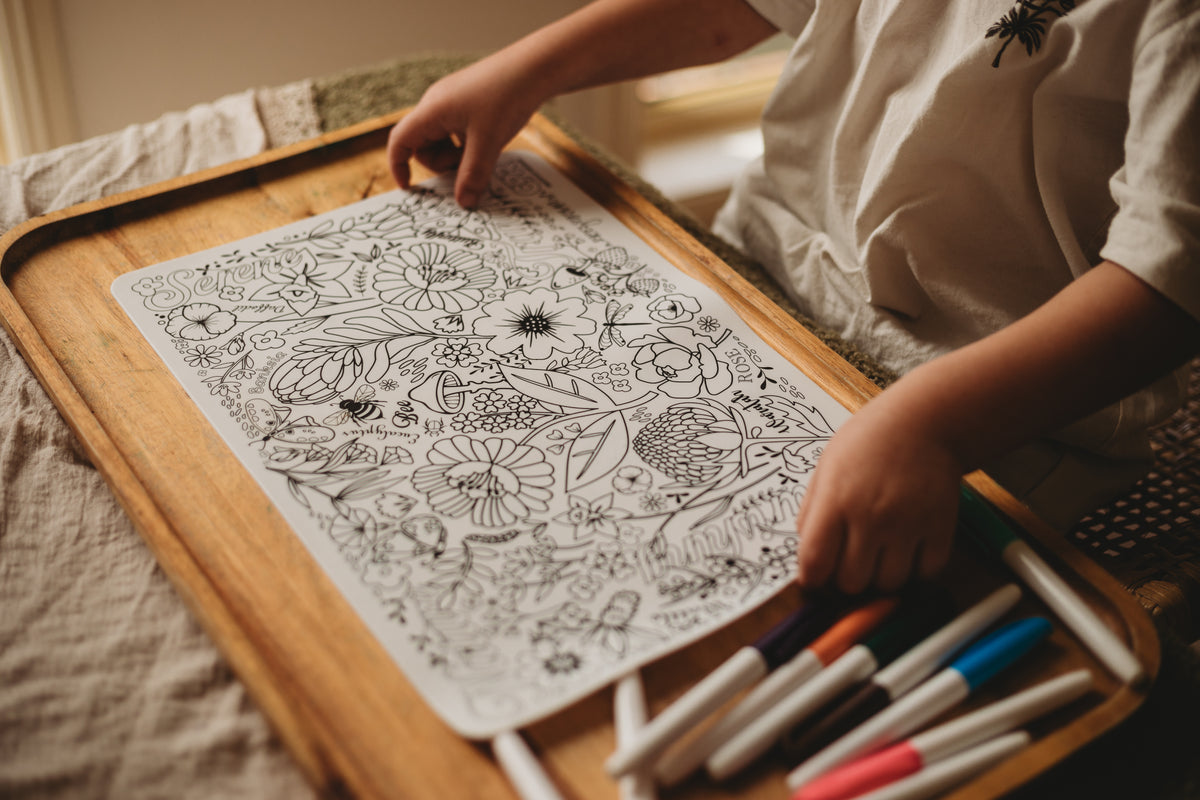 Child using markers on silicone colouring mat featuring Australian flora and fauna, perfect for creative fun.