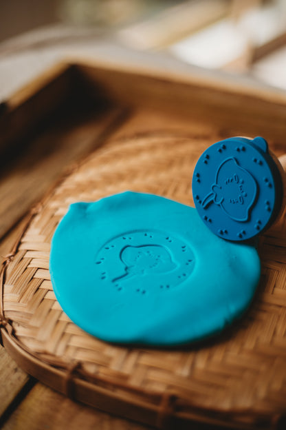 Blue play dough with a stingray stamper