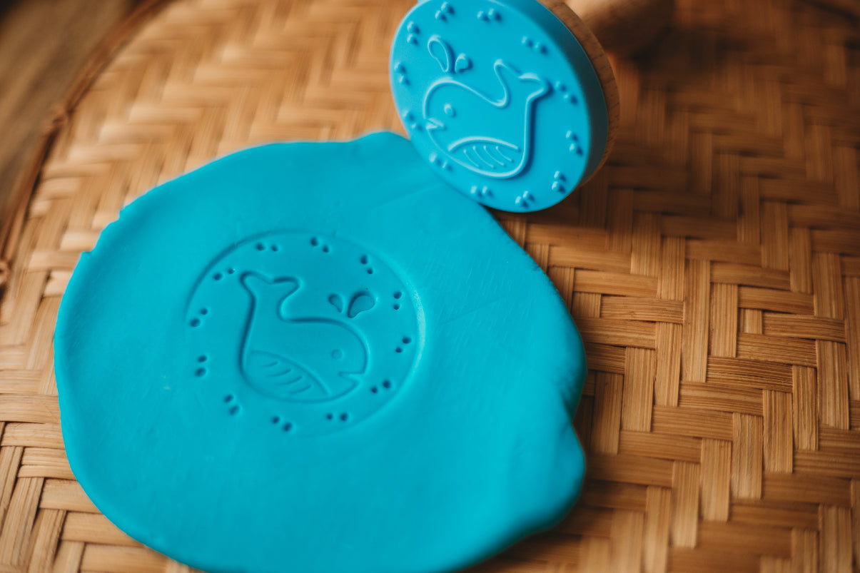 blue silicone moulds with whale designs on playdough