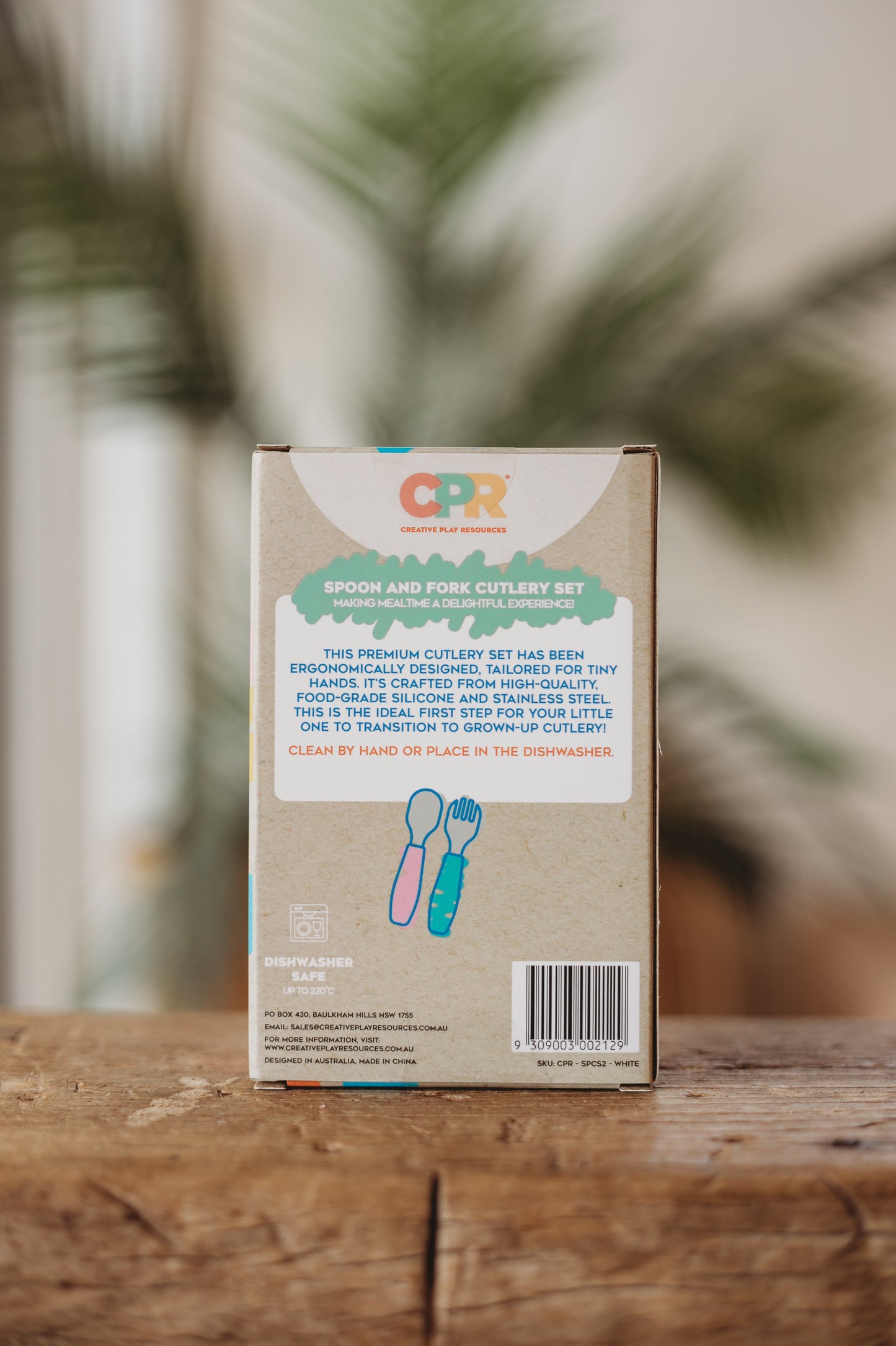 CPR cutlery set packaging on a wooden surface with a blurred natural background