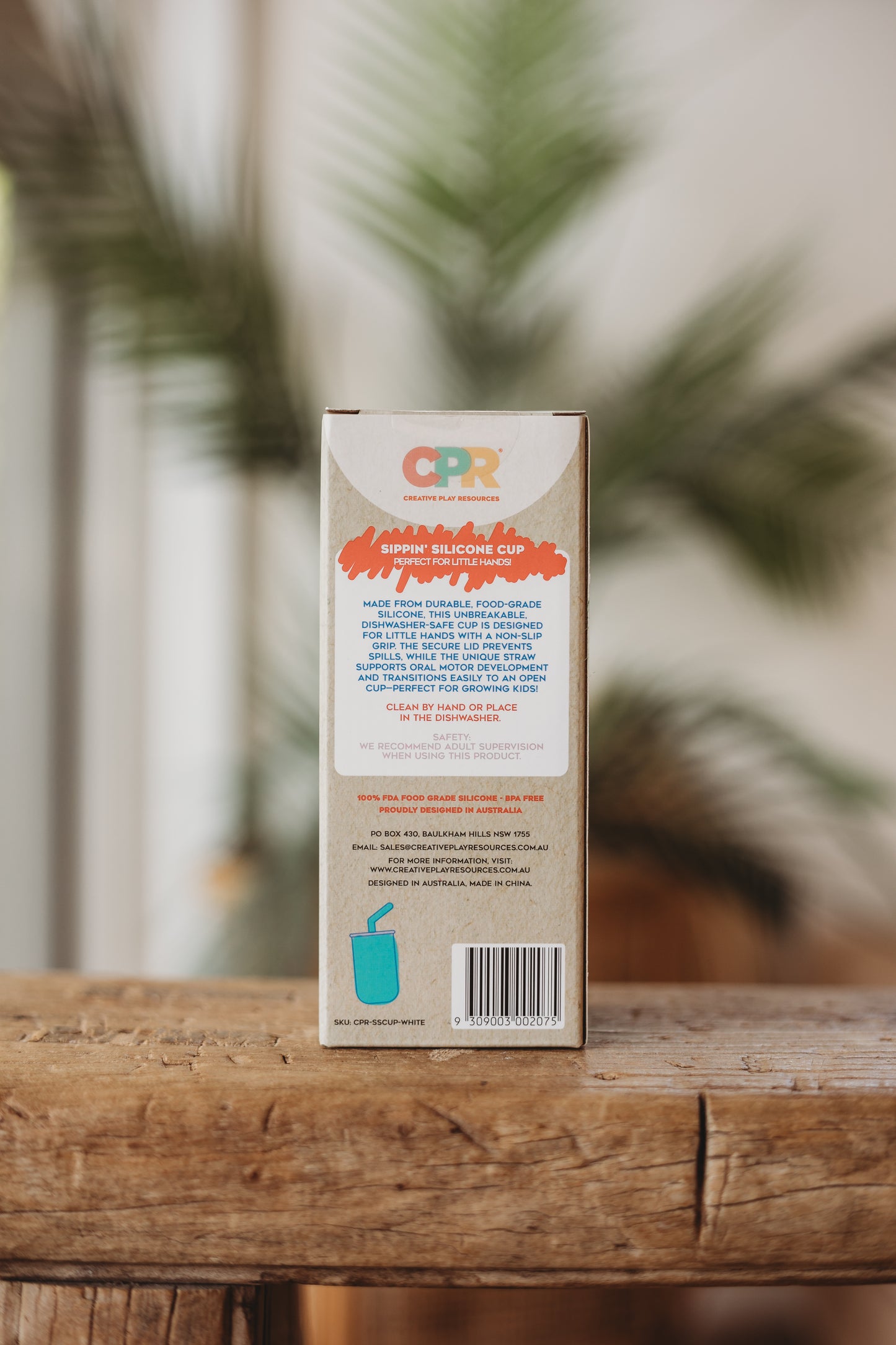 CPR brand product packaging on a wooden surface with blurred greenery in the background