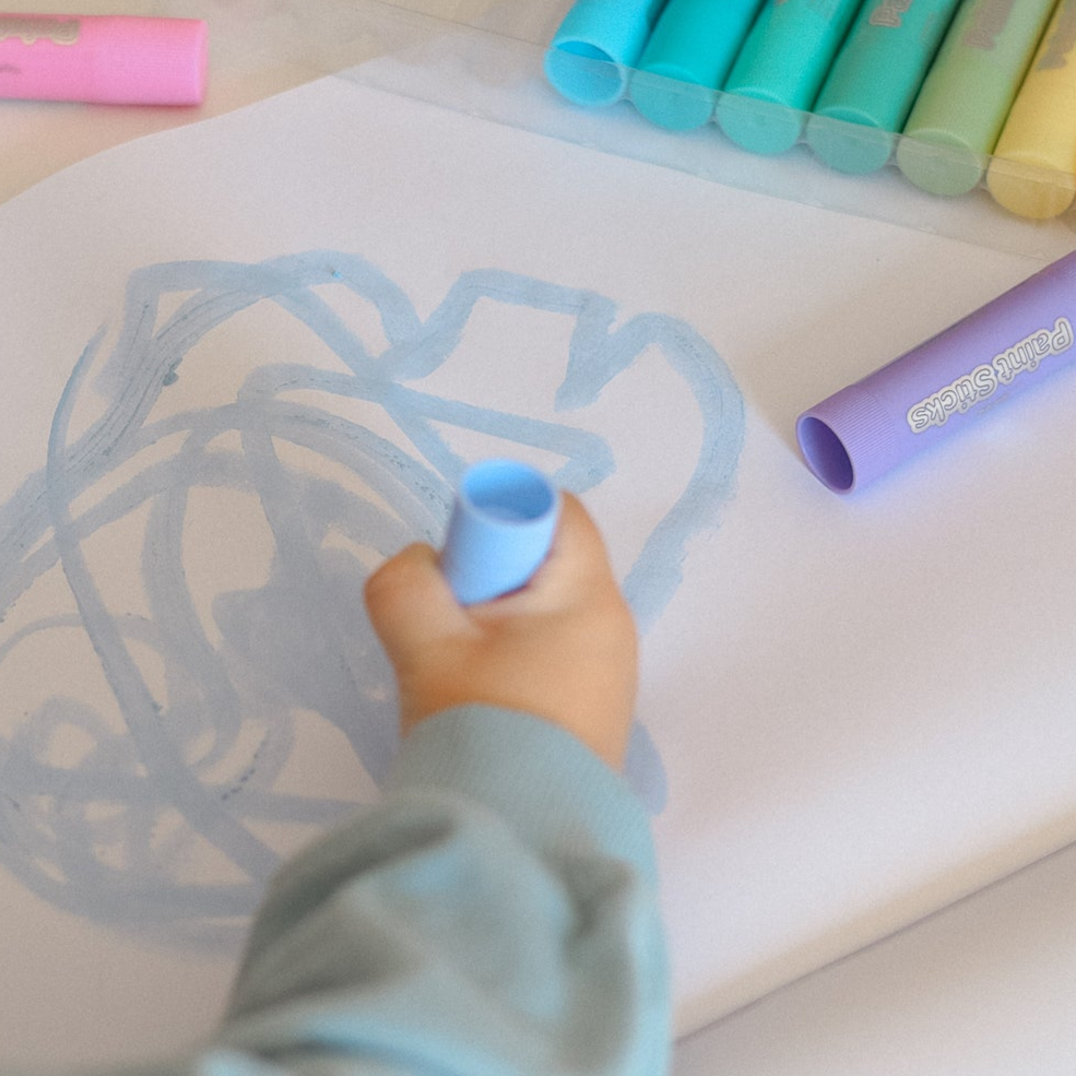 Child drawing with CPR Paint Sticks