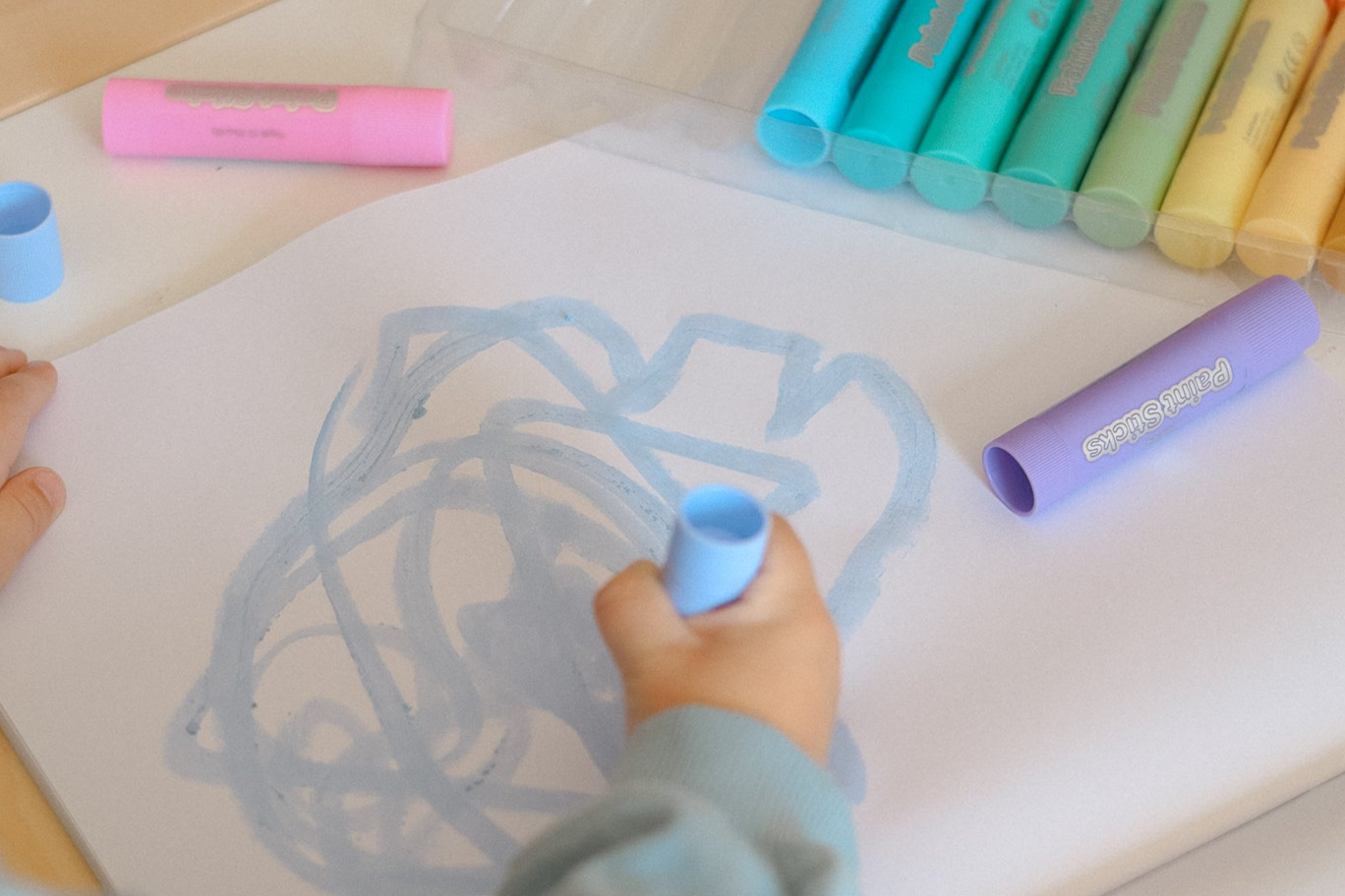 Child drawing with CPR Paint Sticks