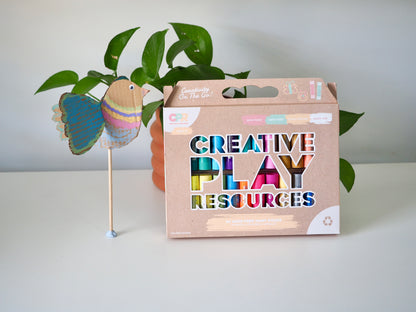 Box labeled 'Creative Play Resources' with a butterfly decoration on a white surface.