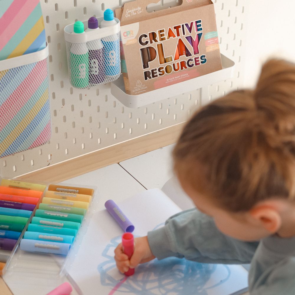 Girl drawing with CPR paint sticks