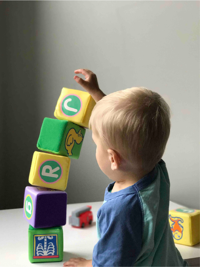 Child playing with building blocks from Creative Play Resources