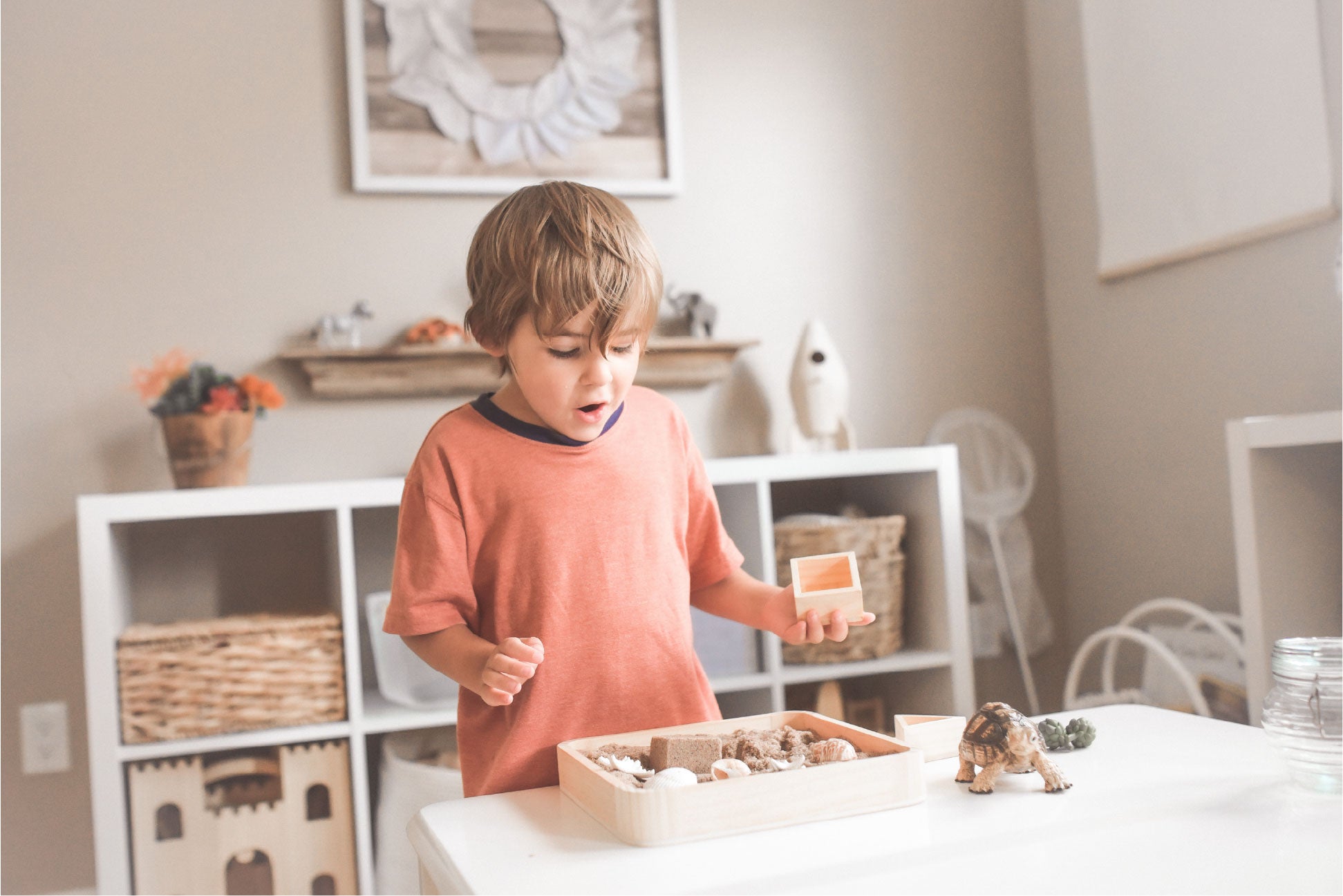 Child playing magic sand and moulds