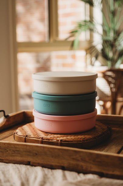 5 Piece Silicone Multifunctional Plate set featured in pink, green, and white, perfect for children's dinnerware set.