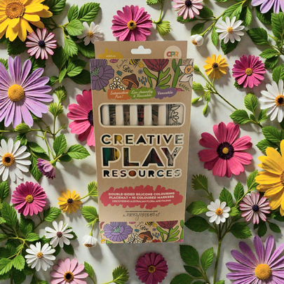 Packaging of Creative Play Resources on a background of colorful flowers